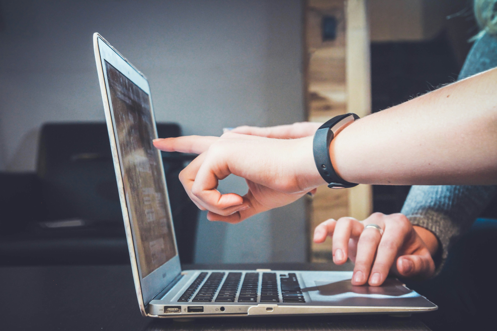 Reviewing Image of pointing to Laptop (stock photo)