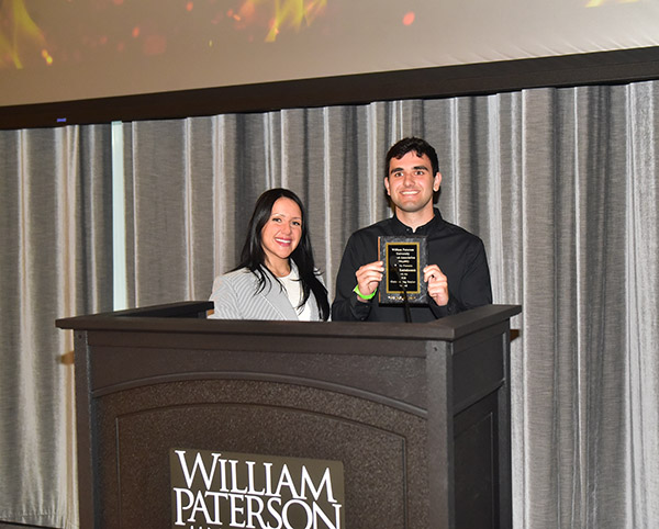 Michael receives the Outstanding Senior award from Nafin Elias.
