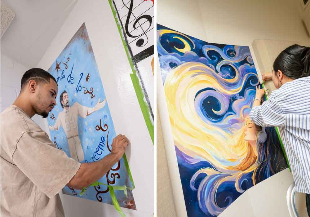 Art students Christian Montanez and Misa Takahashi putting the finishing touches on murals in Shea Center