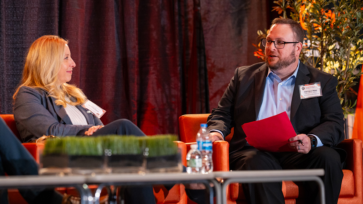 Maria Rollins and Matthew Prail on stage during the panel discussion.