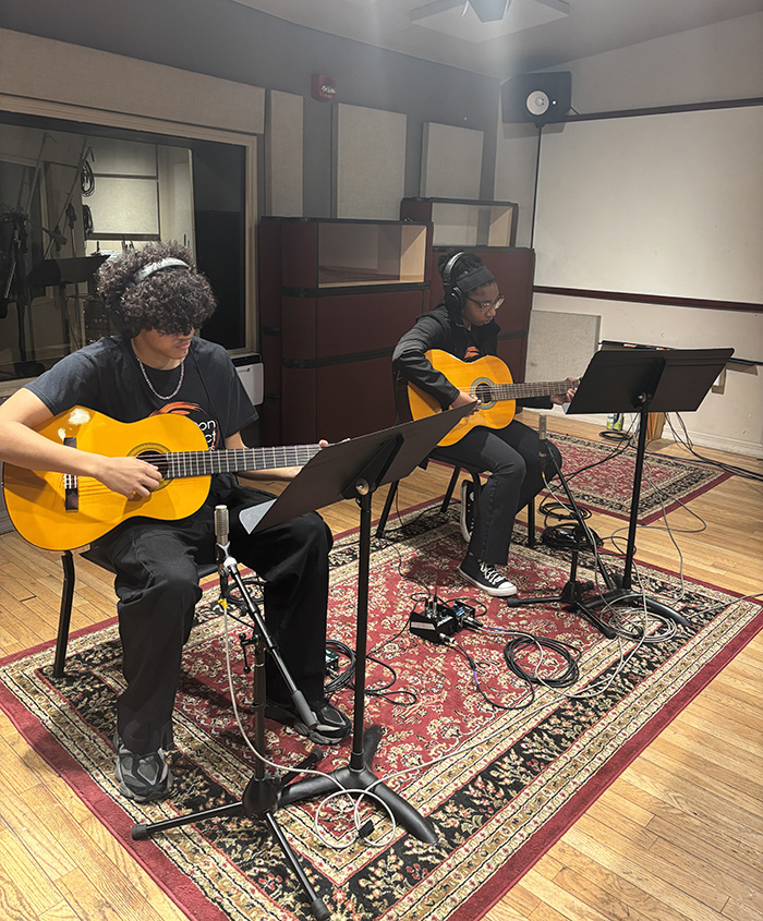 Paterson Music Project musicians playing guitars during a recording session on the William Paterson University campus