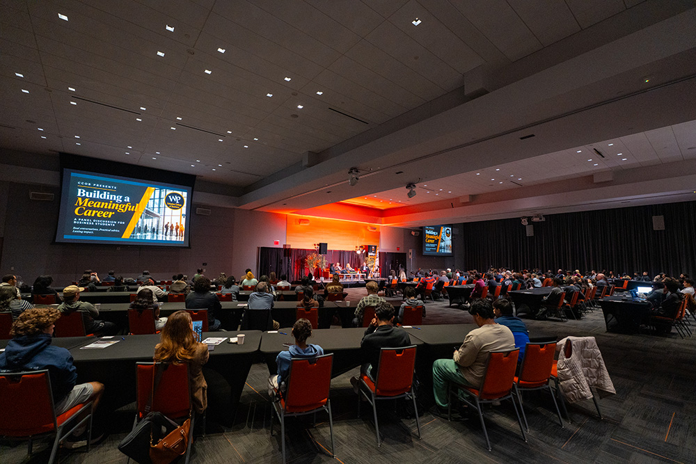 Students fill the University Ballrooms for the Building a Meaningful Career panel.