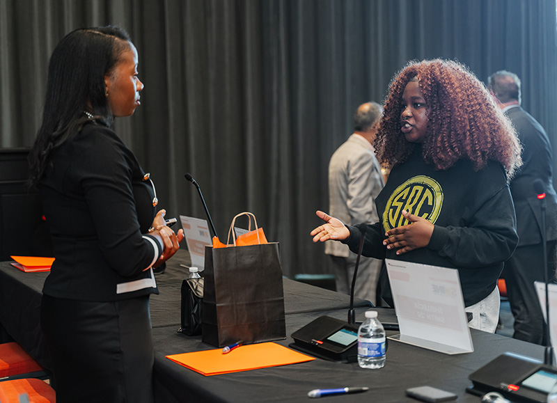 Shellecia Smith connects with a student after the panel discussion.